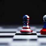 Two chess pawns painted as American and Russian flags