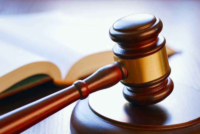 Gavel resting on sounding block beside open book