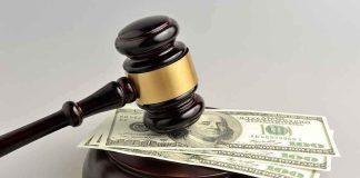 gavel resting on 100 dollar bills