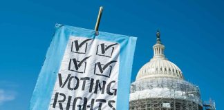 Sign reading "Voting Rights" in front of Capitol building.