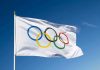 Olympic flag waving against clear blue sky