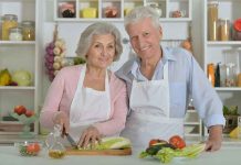 Elderly couple cooking together in the kitchen