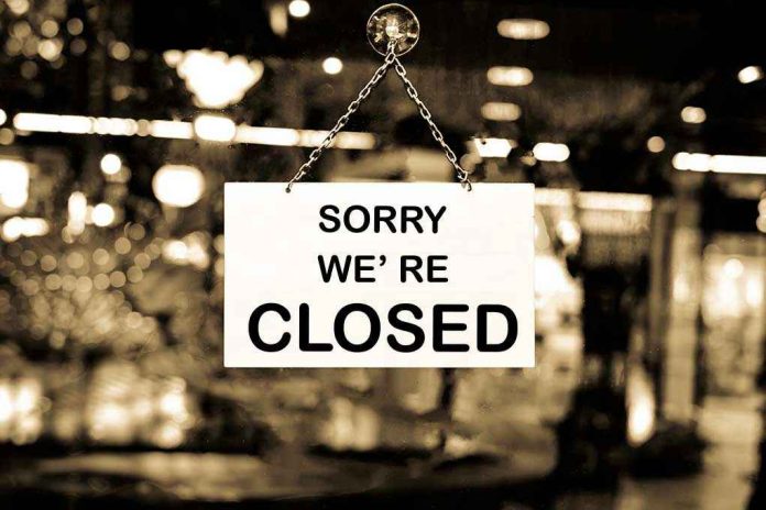 469223957 Closed sign hanging in a shop window