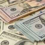 Stacks of various US dollar bills