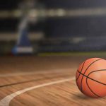 A basketball on a wooden court
