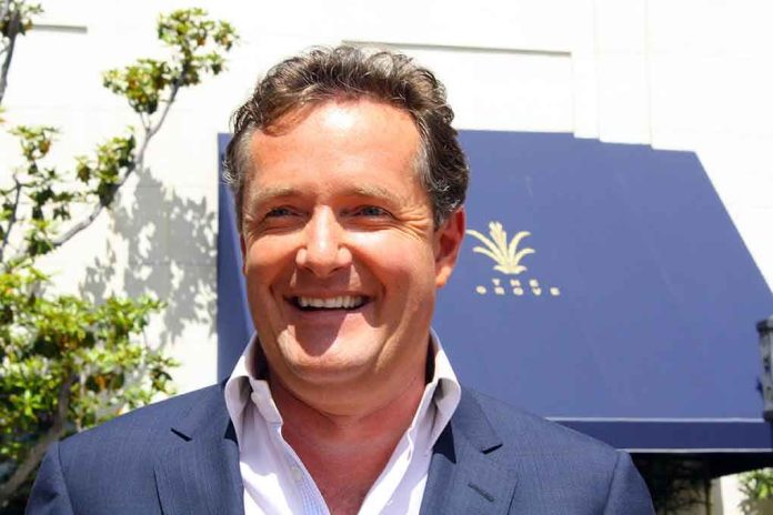 A smiling man in a suit standing outdoors with greenery in the background