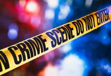 Scary Silence: Witnesses Vanish After Shooting Yellow crime scene tape with blurred lights background