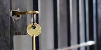 Key in lock of prison cell door