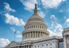 Political Firestorm: Fetterman Breaks Ranks US Capitol building dome under clear blue sky
