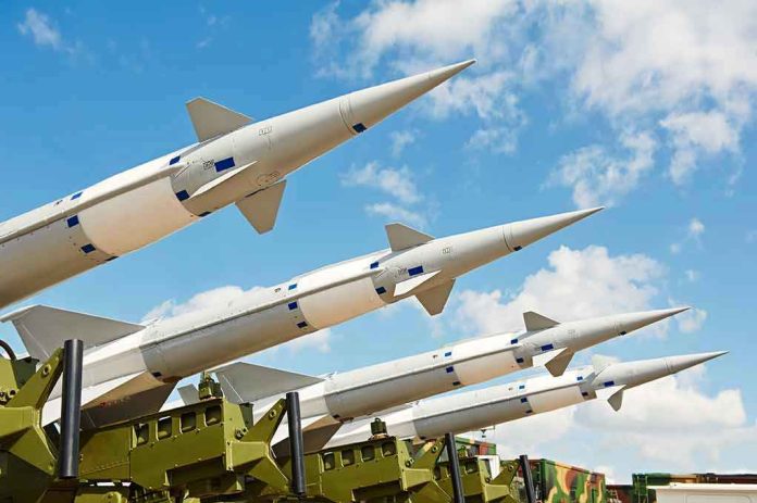 Multiple missiles pointed upward on launchers against blue sky