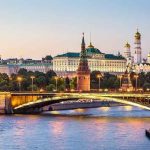 Ukrainian Drones PENETRATE Moscow — Putin STUNNED Illuminated bridge and Kremlin complex across river at twilight