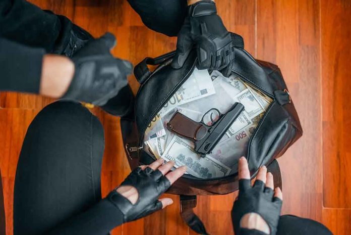 1504435784 Gloved hands around bag with money and gun.