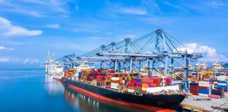 Container ship docked at a busy industrial port