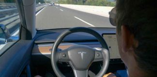 Man using autopilot mode in a Tesla car