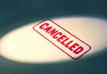 Red Cancelled stamp under a spotlight