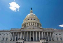 PAYCHECK HYPOCRISY: Lawmakers Cash In During Shutdown U.S. Capitol building against a clear blue sky.