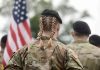 Soldier with braided hair in uniform American flag visible