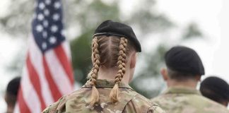 Soldier with braided hair in uniform American flag visible