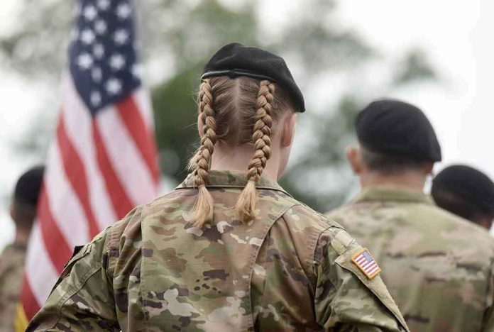 2038666382 Soldier with braided hair in uniform American flag visible