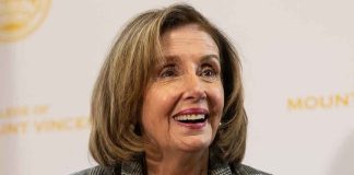 Smiling woman in plaid blazer with pearl necklace