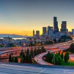 City SUED for Blaming VICTIMS in Attack City skyline with highways at sunset