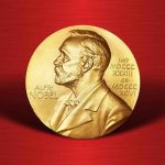 Gold Nobel Prize medal on red background