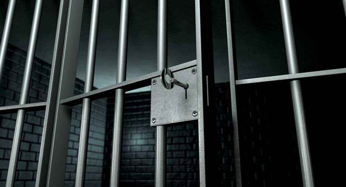 Close up of a locked prison gate with metal bars