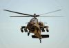 Military Apache helicopter flying in the sky