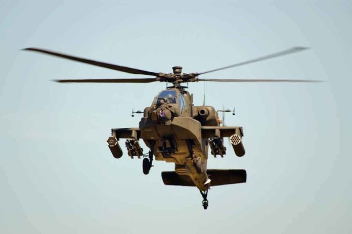 shutterstock_11072761.jpg Military Apache helicopter flying in the sky