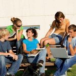 Turning Point USA STORMS Campus Group of students sitting on a bench outdoors, engaged in study and discussion