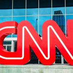 Schwarzenegger SHREDS CNN—Media Bias Exposed Large red CNN logo in front of a glass building