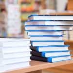 BOMBSHELL Book Exposes White House Cover-Up A stack of neatly arranged books on a wooden table in a bookstore