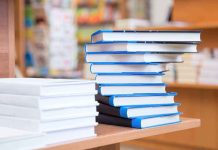 BOMBSHELL Book Exposes White House Cover-Up A stack of neatly arranged books on a wooden table in a bookstore