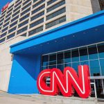 CNN Host STUNS Viewers With Hostage Claim Exterior view of the CNN headquarters with a large red logo and blue entrance