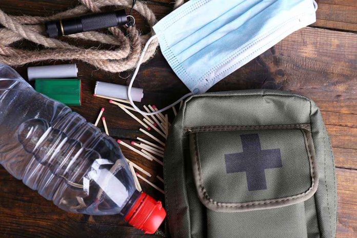 shutterstock_222250729.jpg An assortment of emergency supplies including a first aid kit water bottle face mask and matches