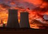 Massive Furlough Threatens Nuclear Security Silhouette of cooling towers against a vibrant sunset sky