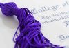 Ghost Students STEAL $13 Million Taxpayer Funds Close up of a purple graduation tassel next to a diploma