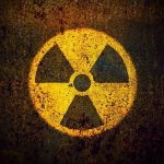 Mystery Drones Breach Nuclear Base Yellow radiation warning symbol on rusty metal surface