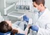 Oral Health SABOTAGE: Are You at Risk?! Dentist examining a patient in a dental chair.