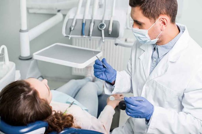 Dentist examining a patient in a dental chair.