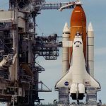 Record-Setting Launch Pace Stuns Rivals Space shuttle on launch pad with support structure