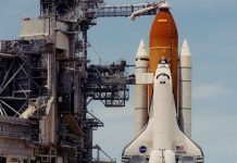 Space shuttle on launch pad with support structure