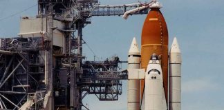 Space shuttle on launch pad with support structure