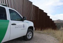 US-Mexico Tensions SPIKE Over Border Actions Border protection vehicle near a large metal fence