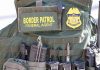 Massive Deportation Spree Rattles U.S. Cities Border Patrol vest with gear and communication equipment.