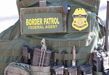 Massive Deportation Spree Rattles U.S. Cities Border Patrol vest with gear and communication equipment.