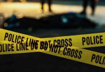 Police tape marking a crime scene at night.