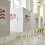 Killer Wins City Seat—Bangor Stunned Voting booths with American flag and VOTE signs