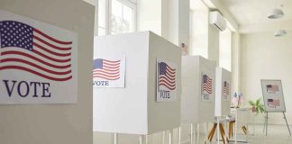 Voting booths with American flag and VOTE signs