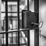 Mississippi Jail Horror: Inmates Used as Enforcers Jail cell door with key in lock.